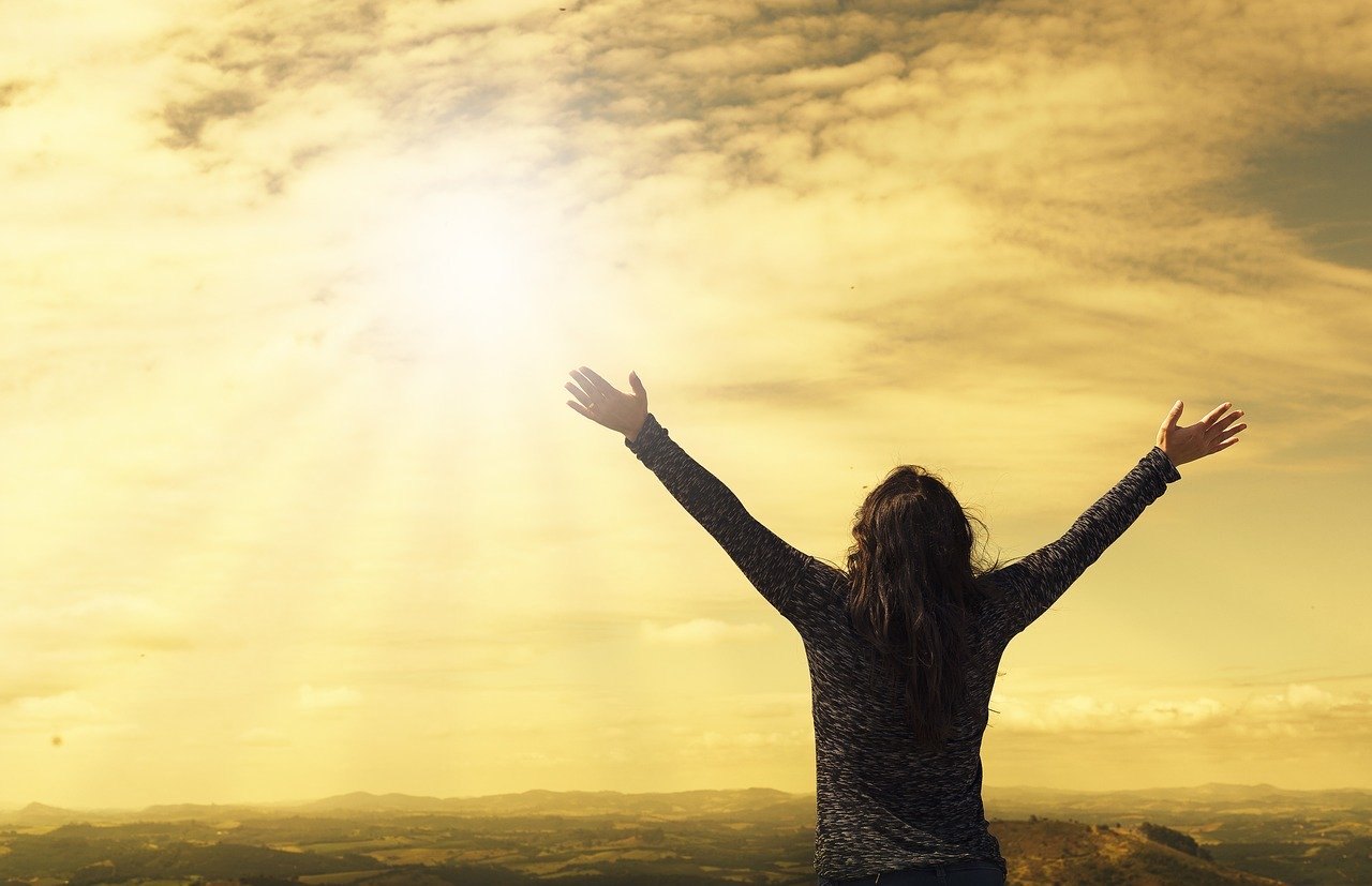 image of woman praising the sun